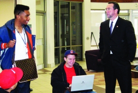 Sinclair Communit College President Steven Johnson visited the Huber Heights Learning Center on Feb. 19. Sinclair students Jordan Martin (left) and Matt Collins (center) spoke with Johnson during his visit. --photo by Joe Stueve