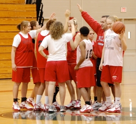 Coach Jeff Dillon and the Lady Pride huddle up for one of the last practices of the season. The Lady Pride finished 4-8 in the OCCAC and 12-13 overall. --photo by Mary Edwards