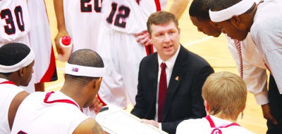 The Pride gather with Coach Price during a break in the action. --archive photo