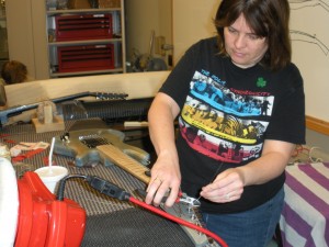 Automation and Control major Angela Profitt puts some of the final touches on her guitar. "It's a little difficult," Profitt said, "and you have to be precise."