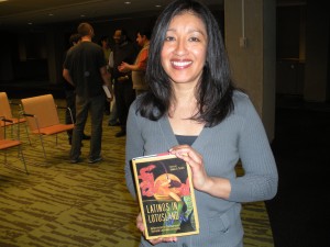 Estella Gonzalez holding "Latinos in Lotusland: An Anthology of Contemporary Southern California Literature" which includes her short story "Act of Faith"