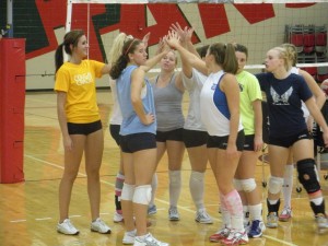 The women's volleyball team displays their unity by huddling together for a chant during practice on Sept. 22.