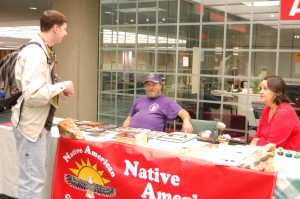 Student Matthew Rizer speaks with Native American Cultural Club members Michael McBride and Debbie McBride during a fundraising table on Oct. 27. “I think the club’s a good organization for the college,” Rizer said.  “It helps clear up the myths and misinformation people might get.”