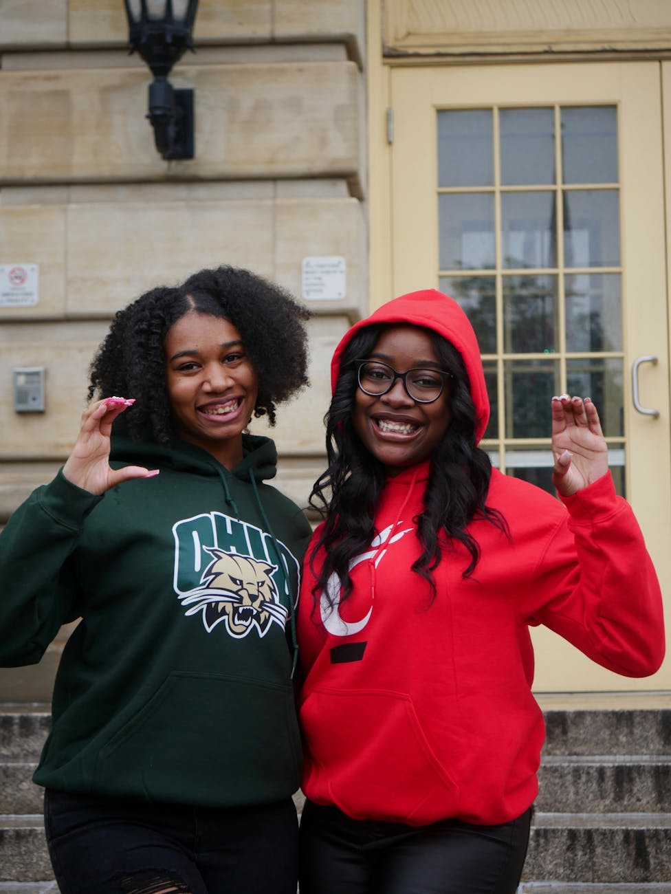 girls gesturing heart together